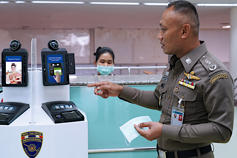 Thai Immigration Bureau deputy commissioner Pol Maj-Gen Surapong Chaichan demonstrates the new temperature detection system at Don Mueang International Airport in Bangkok.